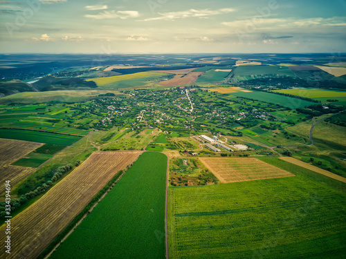 Aerial view of the countryside with village and fields of crops in summer photo