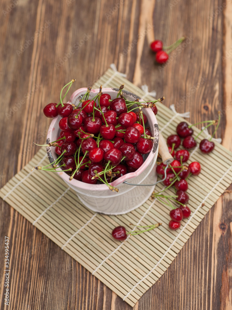 Fresh cherries in bowl on wooden table Fresh cherries in bowl on wooden table