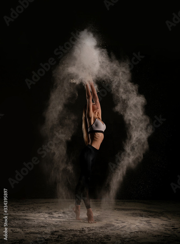 Young woman dancing in dust profile shot