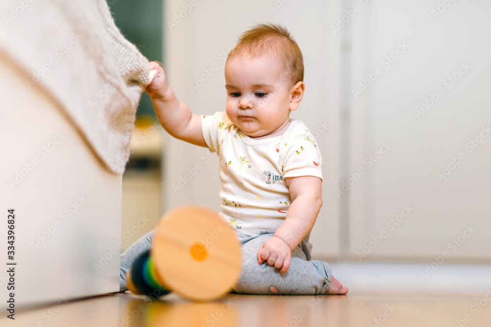 A nine-month-old baby crawls on the floor A nine-month-old baby crawls on the floor