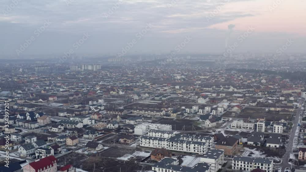 Aerial view of cityscape in suburban of Kyiv, Ukraine. Flight of the drone over city on a winter evening. Dusk sky scenery. Aerial view of cityscape in suburban of Kyiv, Ukraine. Flight of the drone over city on a winter evening. Dusk sky scenery.