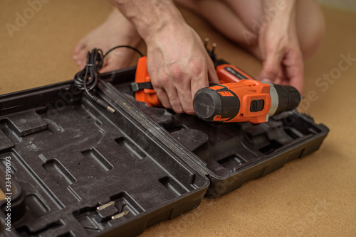 Wallpaper Mural Male hand opening the case with tools for repair of something. Do it yourself Torontodigital.ca