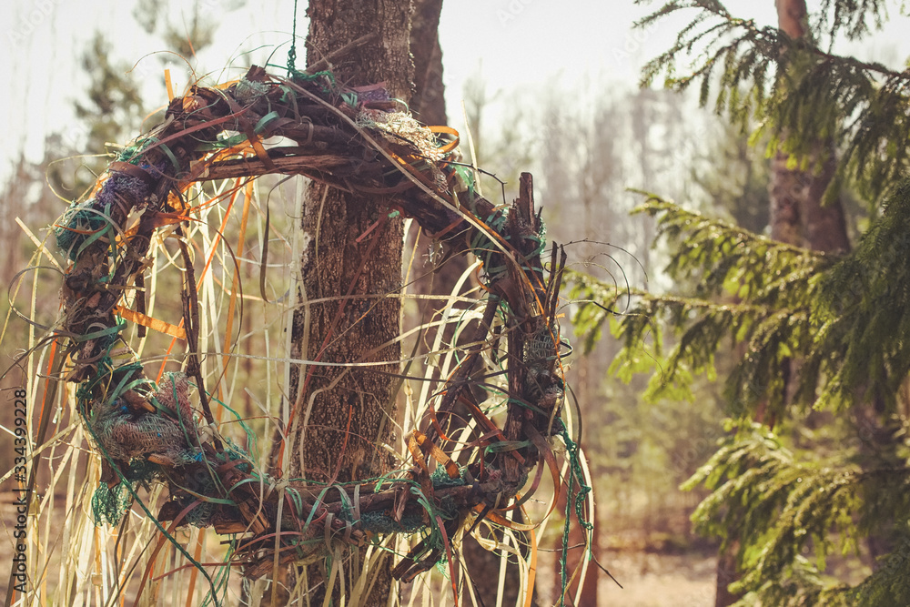 Obraz premium Pagan fantasy medieval legend sunny fresh spring summer ritual Slavic fest Kupala wreath in sunset forest park. Photo in retro hipster style processing