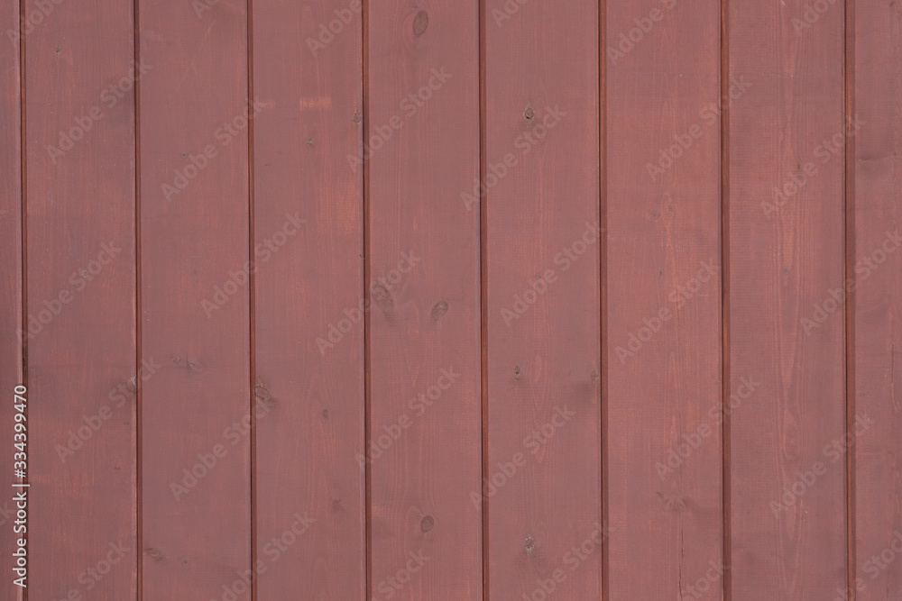 The wooden lining of the facade of the building is red, texture for the background. The wooden lining of the facade of the building is red, texture for the background.