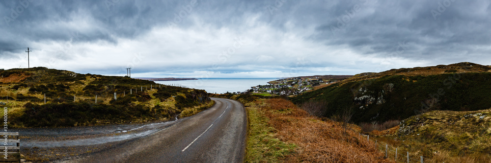 Road going to a small village by the lake somwhere in Scotland