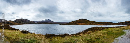 Panoramic view of a snowy mountain peak over the lake - Highlands, Scotland