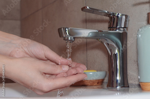 Woman washing hands in the washroom