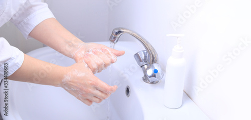 A female doctor washes her hands thoroughly. Pandemic virus COVID-19