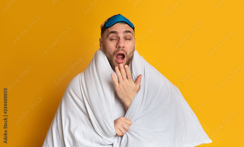 Stay at home in bed concept. Funny guy yawns Stay at home in bed concept. Funny guy yawns