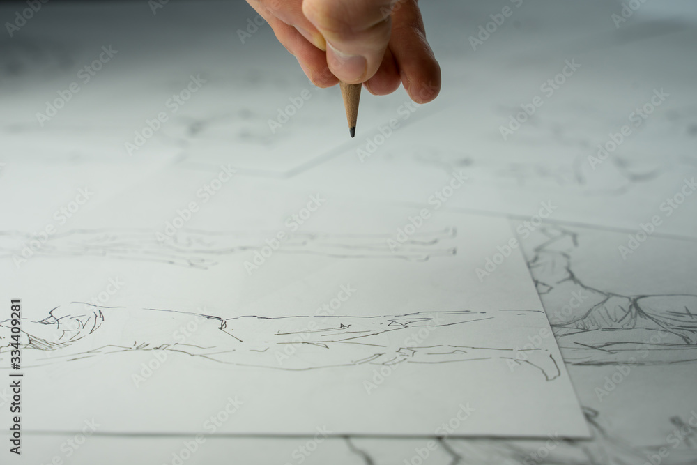 A top view flat lay of many figure drawing pencil and marker sketches. The artist worskspace with male and female drawings and pencils on the white paper, art, craft, creativity, inspiration, concepts A top view flat lay of many figure drawing pencil and marker sketches. The artist worskspace with male and female drawings and pencils on the white paper, art, craft, creativity, inspiration, concepts