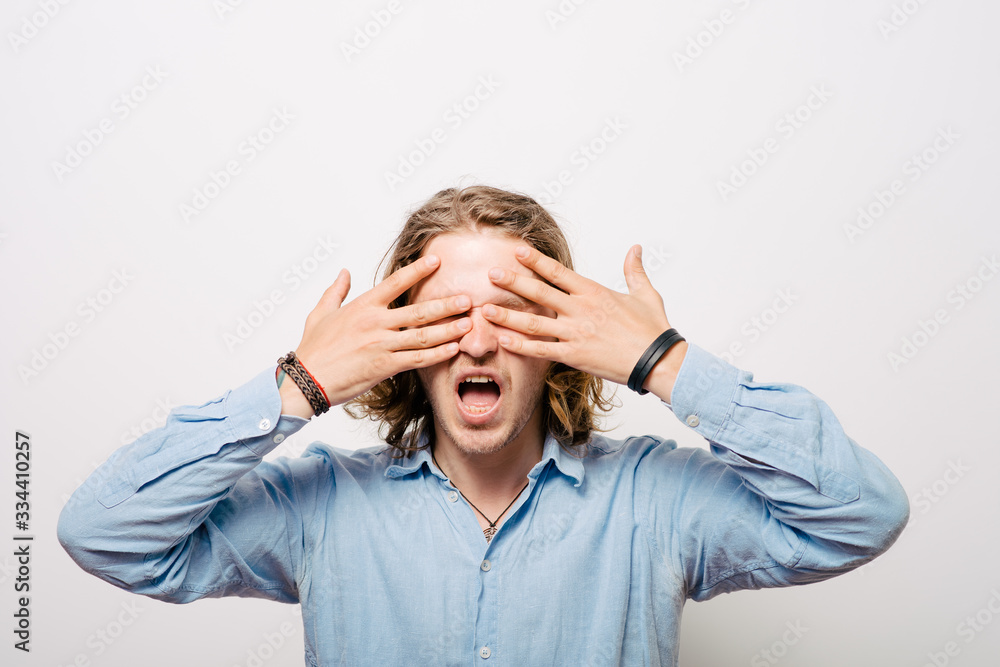 Man closes eyes with her hands