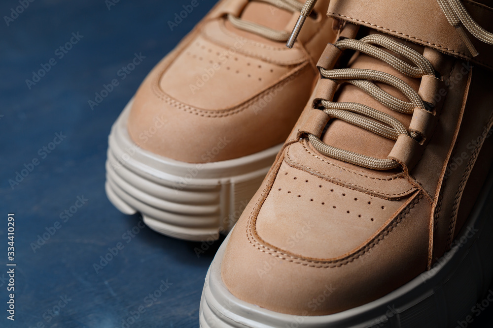 Brown women's leather shoes on a gray background. Fashion trend Brown women's leather shoes on a gray background. Fashion trend