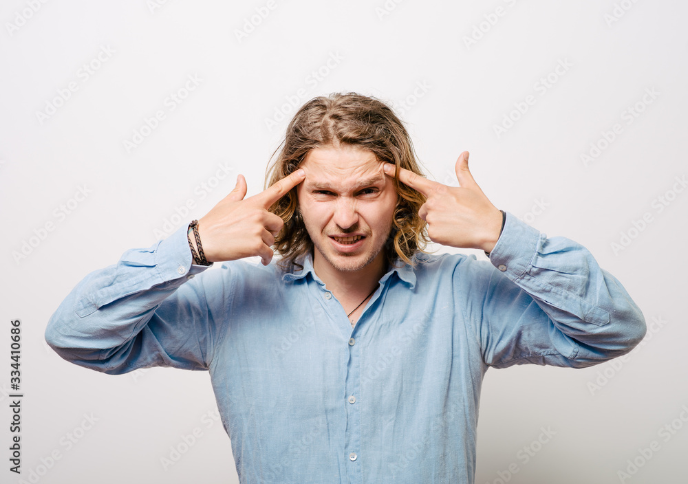 Closeup portrait of angry man gesturing with his finger against his temple, are you crazy? Closeup portrait of angry man gesturing with his finger against his temple, are you crazy?