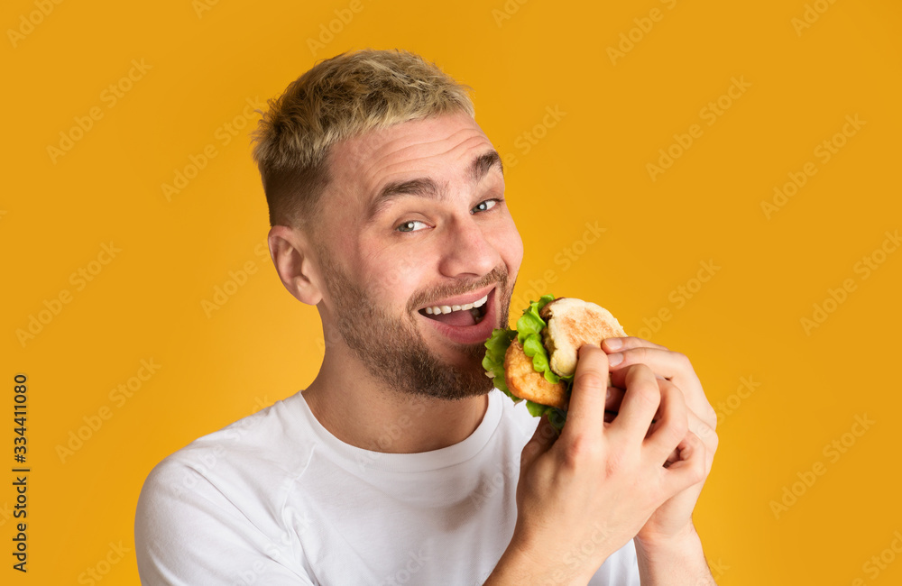 Ridiculous cute man loves fast food, free space Ridiculous cute man loves fast food, free space