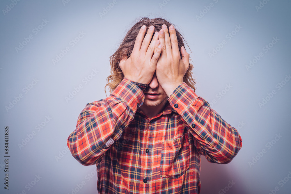 man covers his face by hand man covers his face by hand