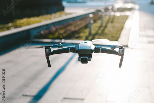Flying drone with the city in background