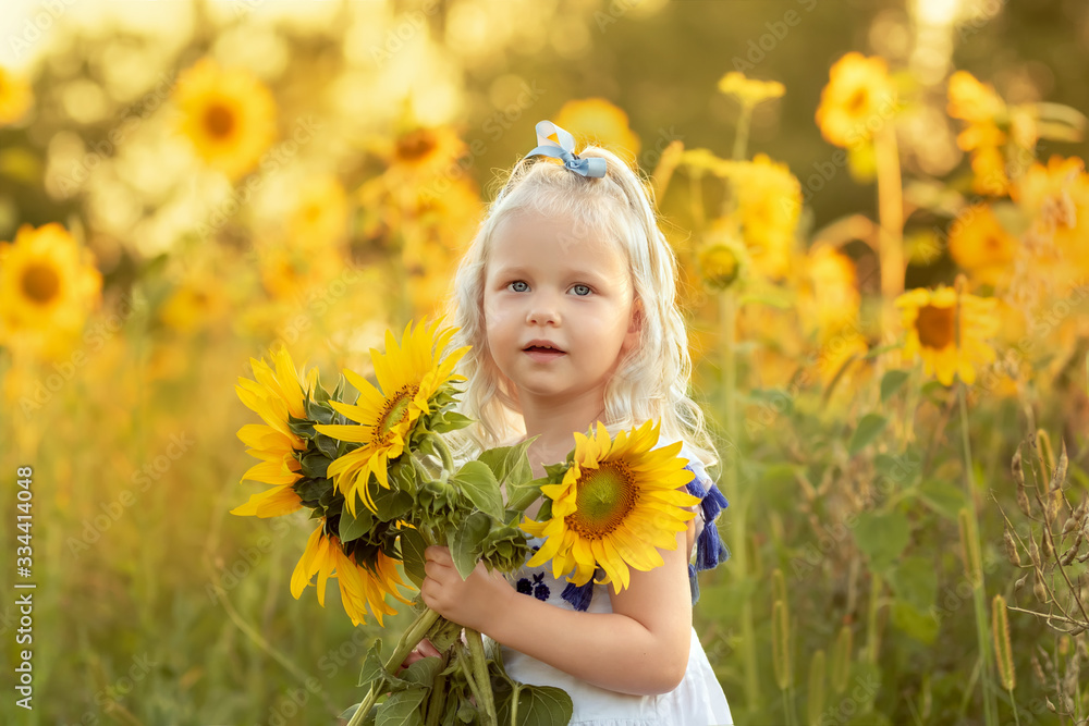 Portrait of a little girl with a bouquet of sunflowers Portrait of a little girl with a bouquet of sunflowers