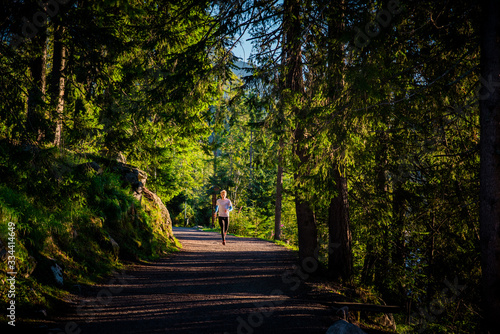 Morning free run in trail by mountains and lake, Strbske pleso, Slovakia