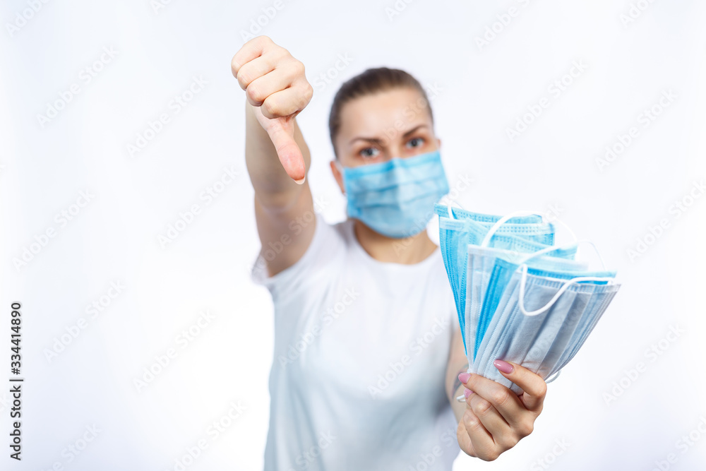 A girl in a protective medical mask holds in her hands means to protect the respiratory tract from the virus. A girl in a protective medical mask holds in her hands means to protect the respiratory tract from the virus.