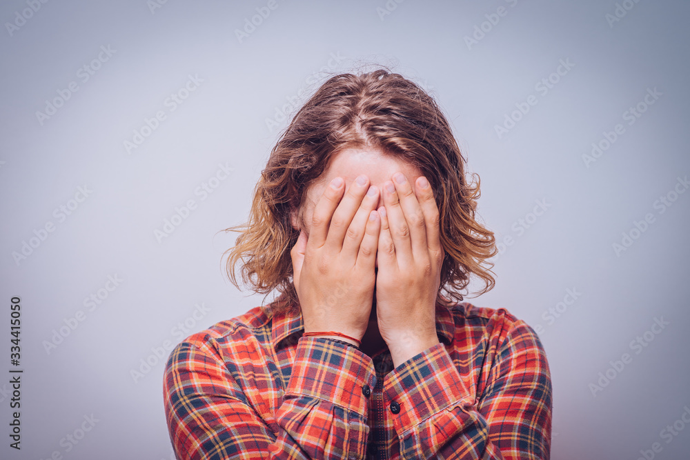 man covered his face with hand