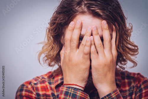 man covered his face with hand