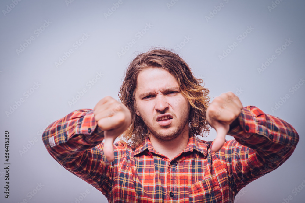 man showing a thumb down gesture man showing a thumb down gesture