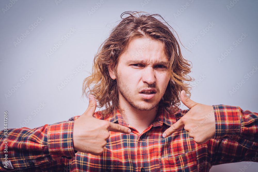 Male hand forefinger pointing to himself on the chest. Gesture. who am i. On a gray background Male hand forefinger pointing to himself on the chest. Gesture. who am i. On a gray background