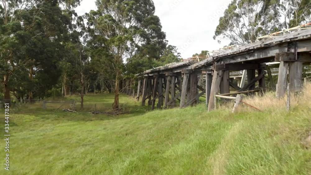 Aerial shot moving backwards away from an old run down wooden railway bridge. Aerial shot moving backwards away from an old run down wooden railway bridge.