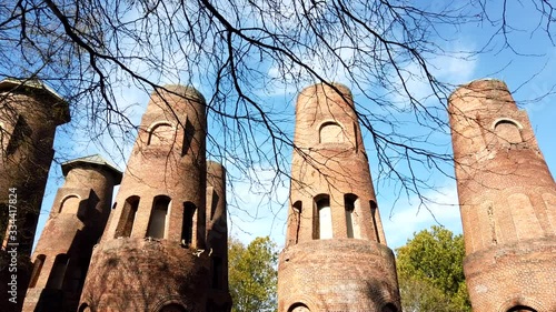 Coplay Cement Kilns in Saylor Park, Lehigh, Pennsyvania are historical kilns from portland cement manufacturing history in the area. Clouds passing in sky over brick industrial colums. photo