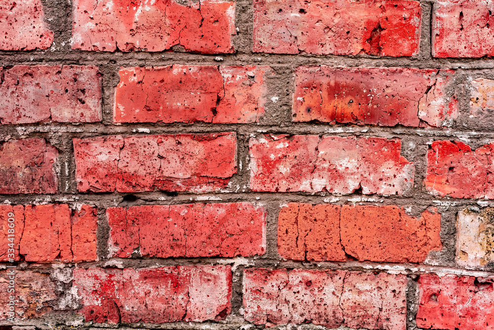 Texture of a brick wall with cracks and scratches which can be used as a background Texture of a brick wall with cracks and scratches which can be used as a background