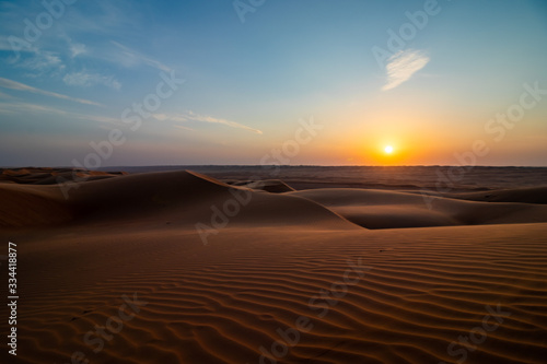 Sunset on sand dune in Wahiba sands desert near Bidiyya in Oman