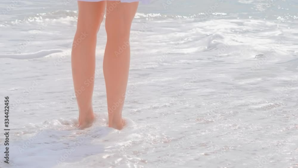 Beach travel, woman in white dress on sand beach. Beach travel, woman in white dress on sand beach.