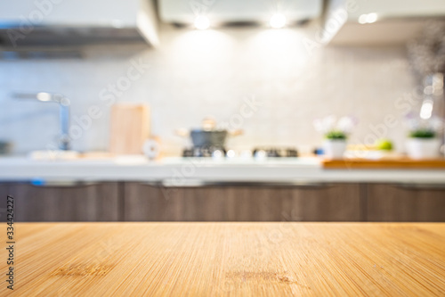 Wooden table top on blur kitchen room background. For displaying the assembly product or visual arrangement of the configuration keys