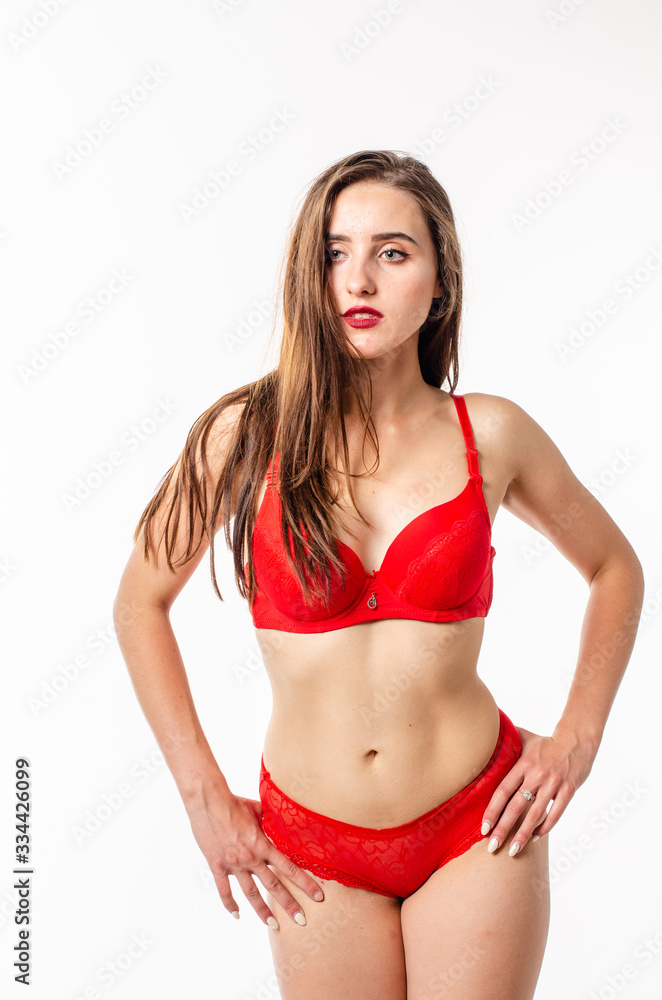 Fototapeta premium Beautiful, sexy, elegant blonde woman in red lingerie on a white background