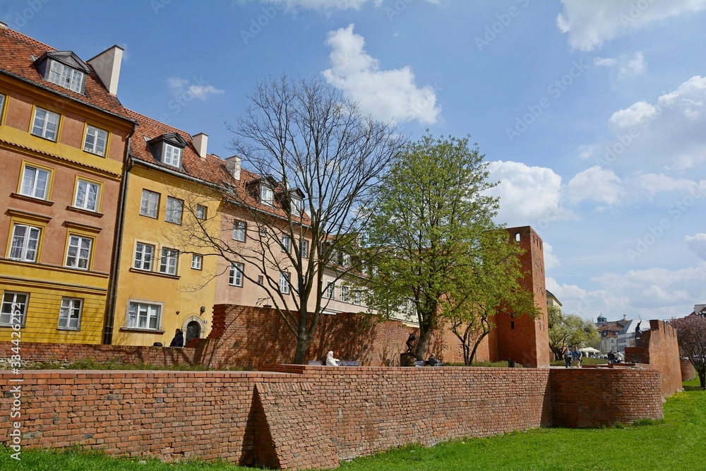 Warsaw Old city. Houses and city wall. Earthworks. Red brick city wall. Small street, Rycerska street, in the medieval old city in Warsaw. The oldest historical district of Warsaw