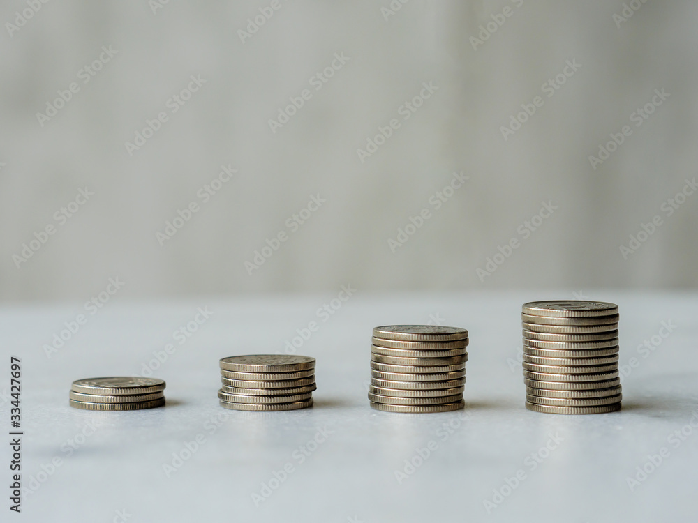 Ascending coin columns form an upward line with copy space Ascending coin columns form an upward line with copy space