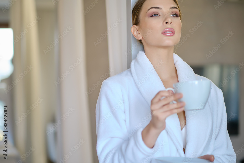 woman resting in a bathrobe at home