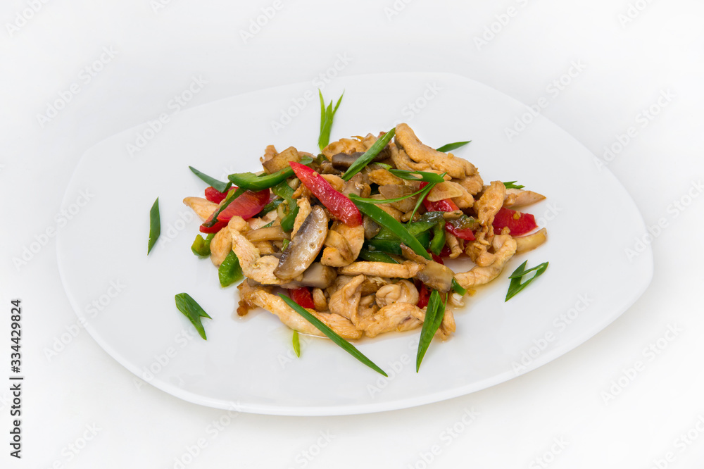 Thin-cut fish fried in oil, as well as fried pepper, tomato and onion feathers, finely cut for decoration