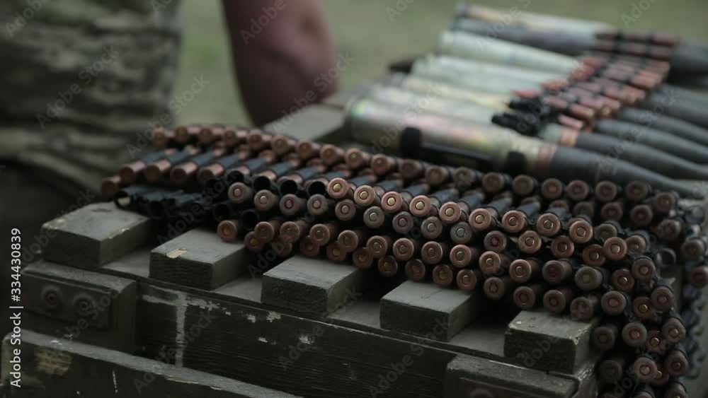 A soldier carries, charges, machine-gun belts A soldier carries, charges, machine-gun belts