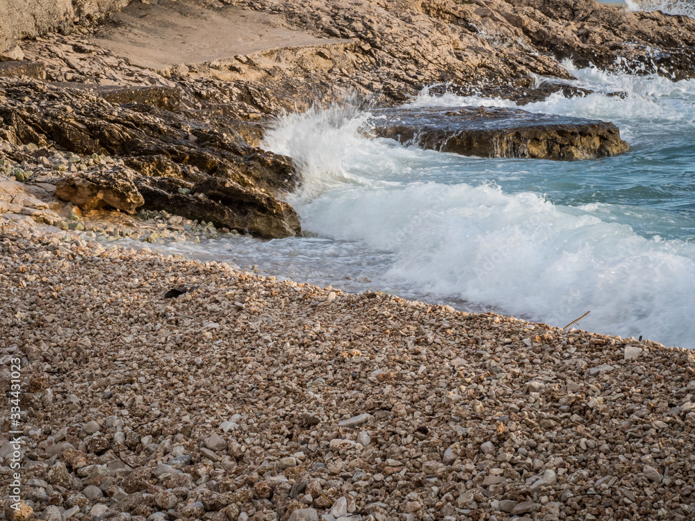 Tide coming on pebble beach in Croatia Tide coming on pebble beach in Croatia