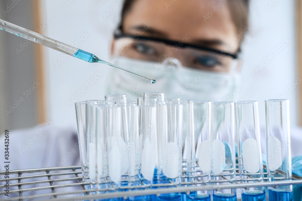 Biochemistry laboratory research, Chemist is analyzing sample in laboratory with equipment and science experiments glassware containing chemical liquid Biochemistry laboratory research, Chemist is analyzing sample in laboratory with equipment and science experiments glassware containing chemical liquid