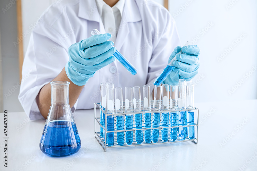 Scientist or medical in lab working in biotechnological laboratory using equipment for research with mixing reagents in glass flask in clinical laboratory Scientist or medical in lab working in biotechnological laboratory using equipment for research with mixing reagents in glass flask in clinical laboratory
