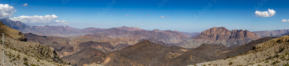 Mountain and valley view along Wadi Sahtan road in Al Hajir mountains between Nizwa and Mascat in Oman