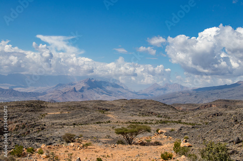 Mountain and valley view along Wadi Sahtan road in Al Hajir mountains between Nizwa and Mascat in Oman