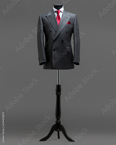 Atelier to repair clothes, Stylish look, Fashion look, Men look, Wedding style, Fashion concept, Brand clothing, Classic costume,Suit on grey background. Store display. Classic style.