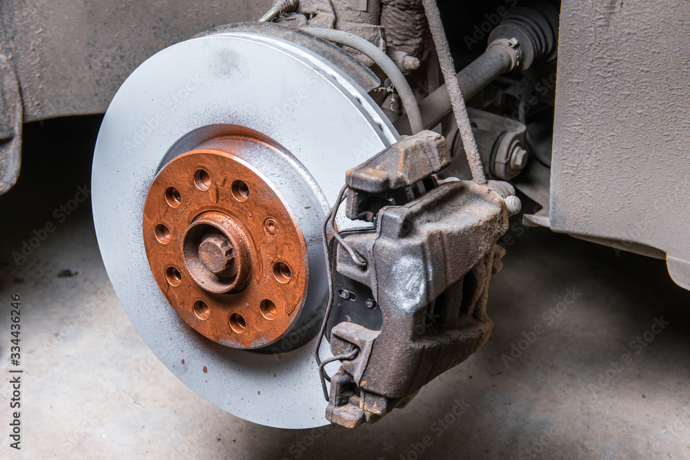 New brake disc with pads on the car. Replacement in your own garage. New brake disc with pads on the car. Replacement in your own garage.