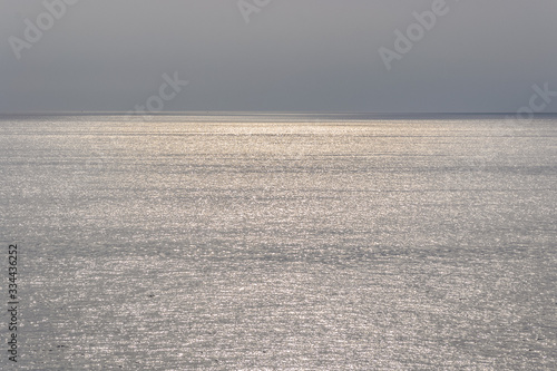 Just the horizon over the water of the mediterranean sea at sunset time with a warm soft light 