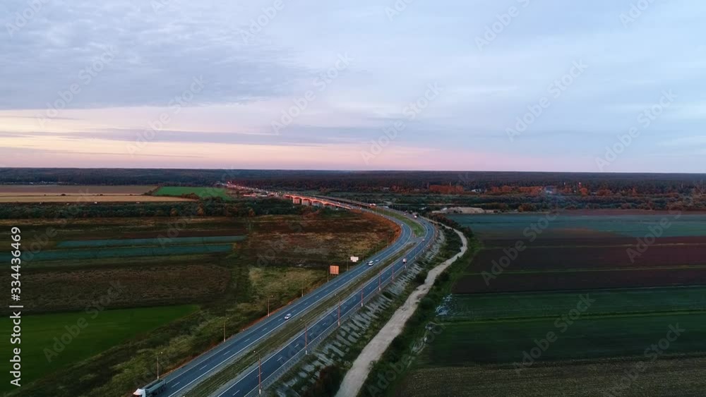 Cars traffic on highway at sunset. Aerial view. Beautiful landscape. Cars traffic on highway at sunset. Aerial view. Beautiful landscape.