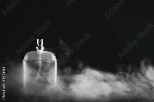 Bottle of men's fragrance on a dark background