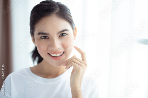 Portrait of beautiful young asian woman happiness standing in bedroom white background
